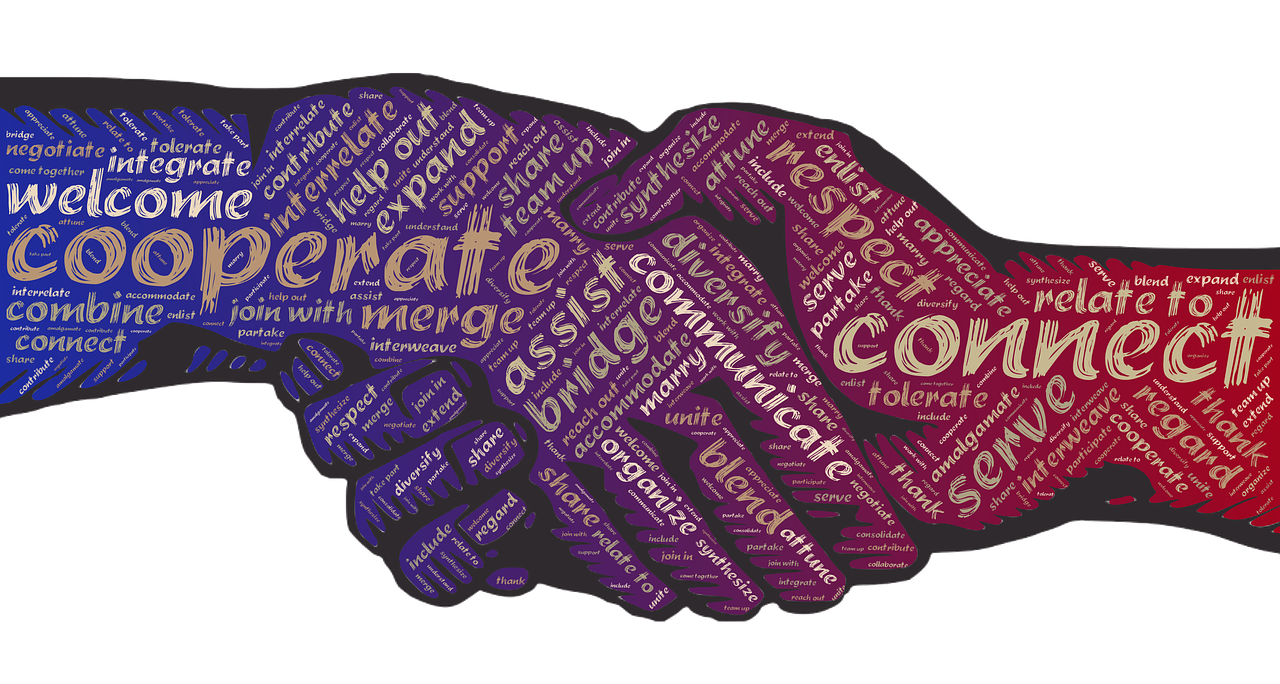 Two hands shaking, symbolizing partnership and support in the recovery community.